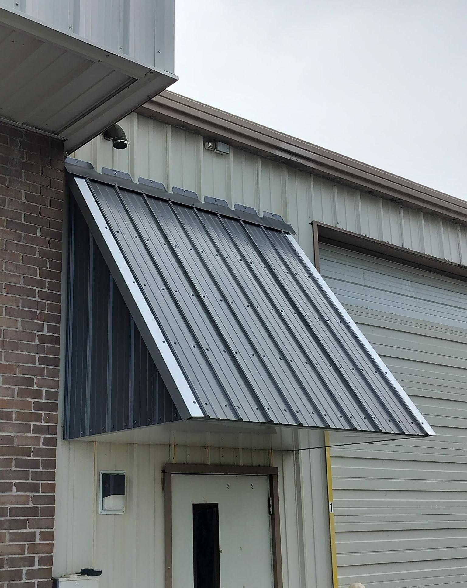 Brick building awning installation, close view